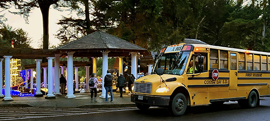 School bus in front of Holiday Lights at Shore Acres