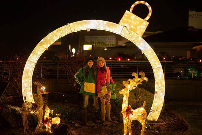 Lighted decorations with girls at downtown event.