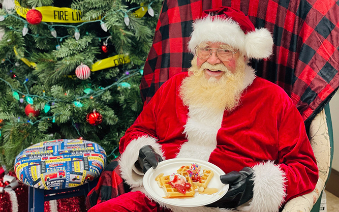 Santa holding a plate of waffles